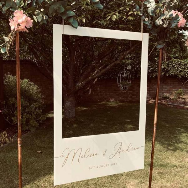 Beautiful Copper Arch with a hanging Polaroid Prop Wedding Garden