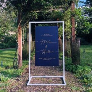 White Metal Frame with Navy Calligraphy Welcome Sign hanging
