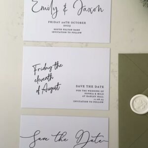 Save the Date cards laid out next to a Sage Envelope and Wax Seal